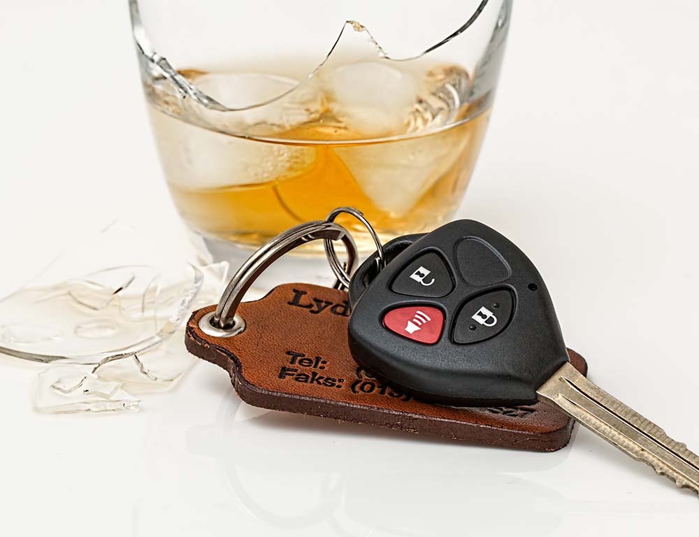 broken liquor glass with car keys Car keys in front of a broken glass of liquor leading to a DUI in Metro Atlanta.